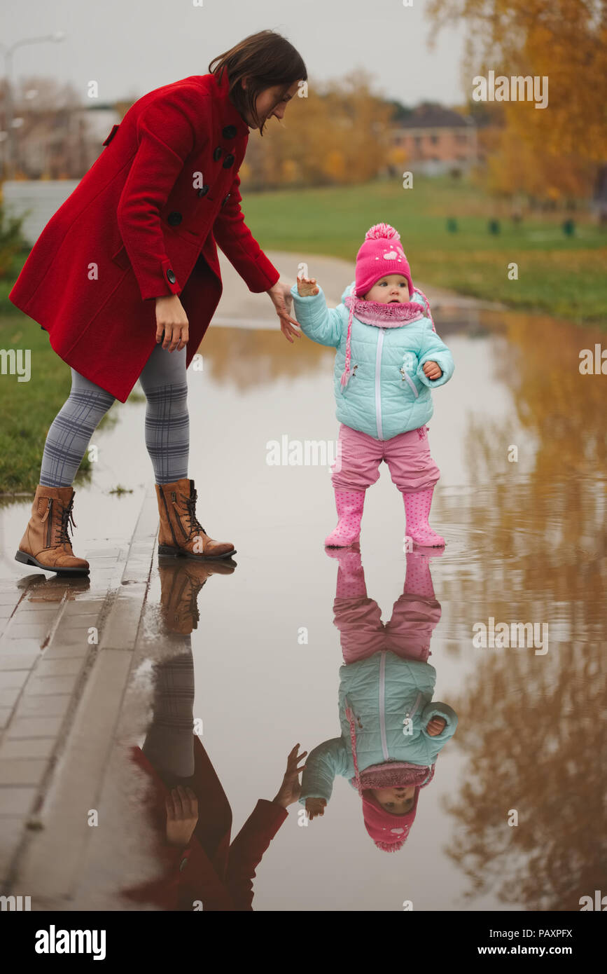 little girl with rubber boots in puddle Stock Photo - Alamy