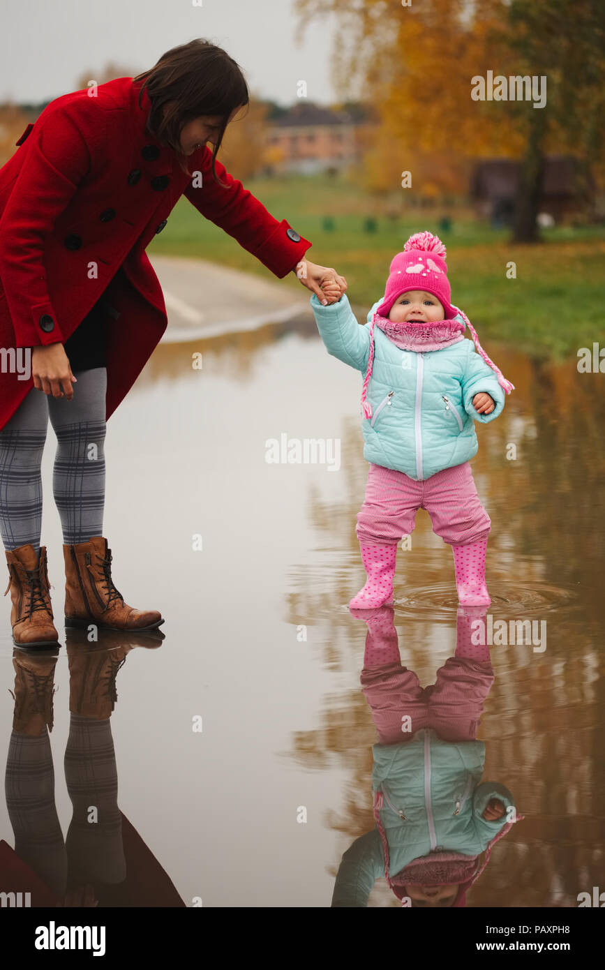 little girl with rubber boots in puddle Stock Photo - Alamy