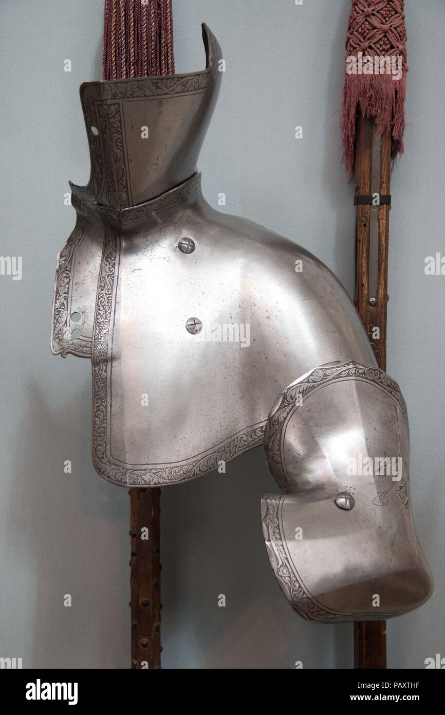 Reinforcing Plates of Armor for the Tilt. Culture: Austrian, Innsbruck. Dimensions: grandguard (21.138.2): L. 12 3/4 in. (32.39 cm); W. 14 1/8 in. (35.86 cm); Wt. 4 lb. 4 oz. (1928 g); tilting buffe (21.138.3): L. 15 in. (38.1 cm); W. 9 3/4 in. (24.77 cm); Wt. 4 lb.11 oz. (2126 g); elbow guard (21.138.4): L. 10 3/4 in. (27.31 cm); W. 7 7/8 in. (19.99 cm); Wt. 2 lb. 13 oz. (1276 g). Date: dated 1551.  For the joust, or tilt, in the Italian fashion, the grandguard protecting the upper left chest and neck was close-fitting in contrast to the German use of a projecting tilt targe (cape-like defens Stock Photo