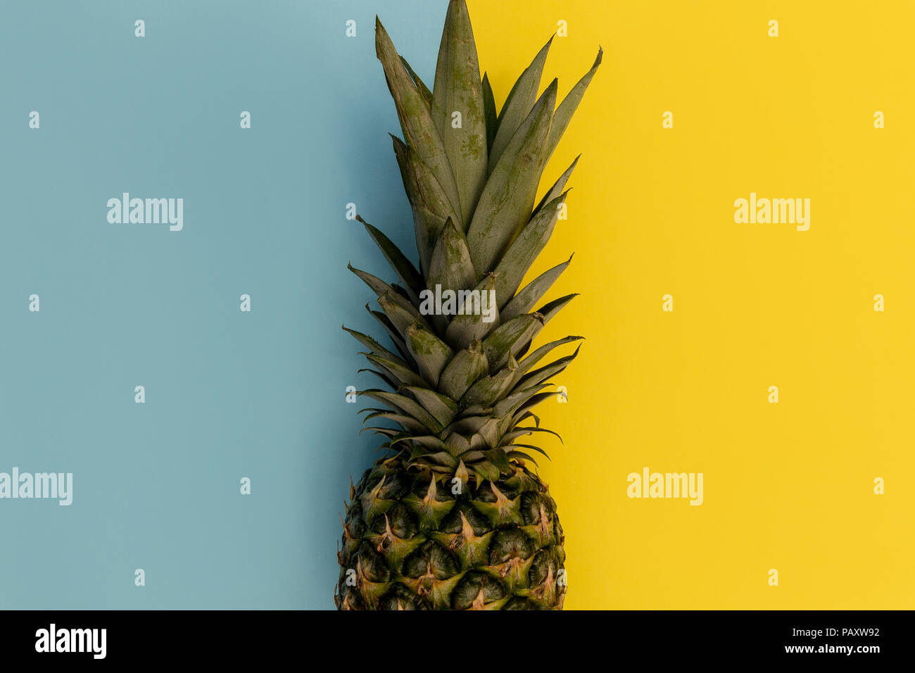 Pineapple fruit on bright yellow background minimal summer food concept Stock Photo