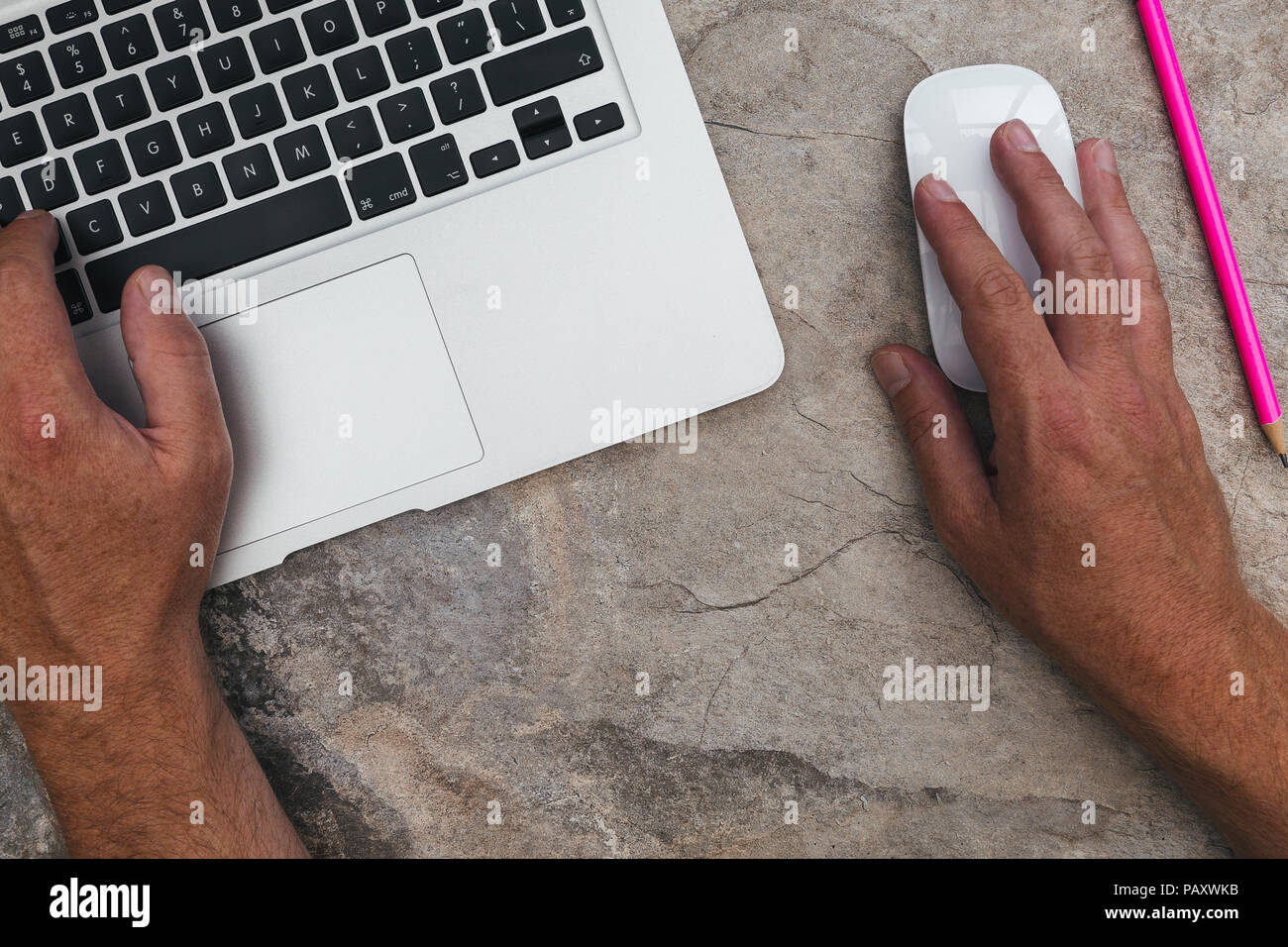 Man working with laptop computer and mouse on marble background Stock Photo