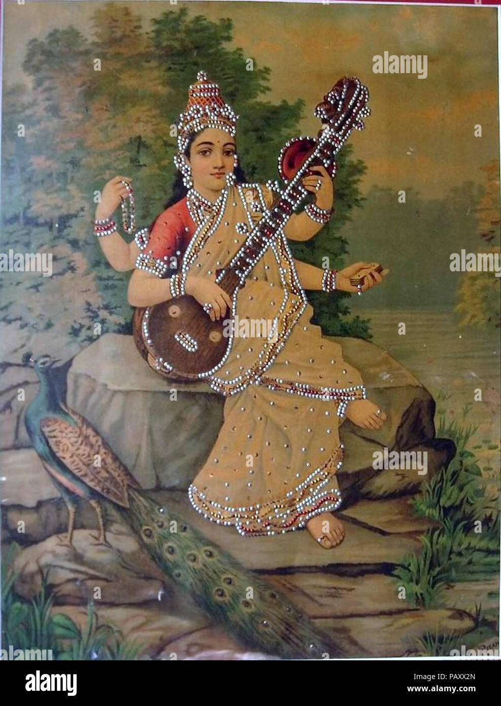 A vision of Sarasvati from the Ravi Varma studio, c.1910's; it's been decorated with sequins. Stock Photo