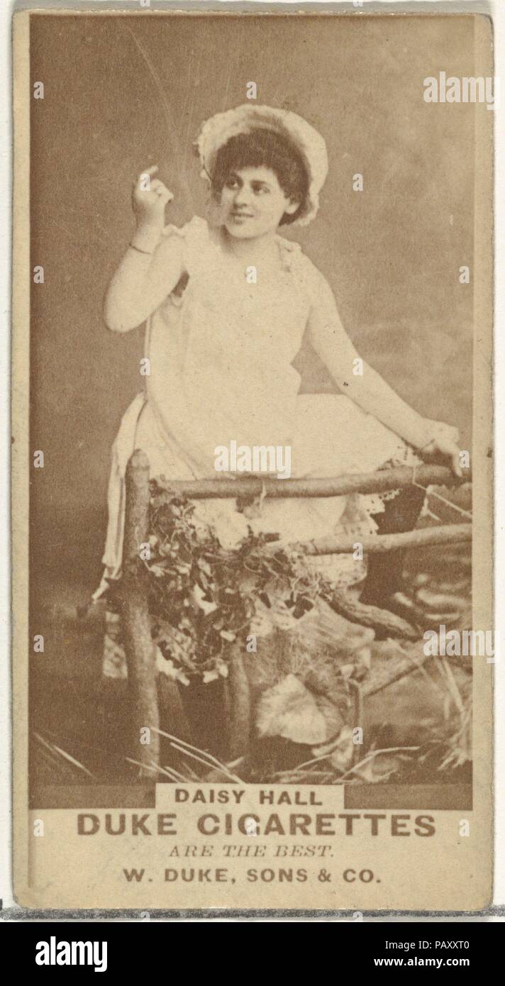 Daisy Hall, from the Actors and Actresses series (N145-7) issued by Duke Sons & Co. to promote Duke Cigarettes. Dimensions: Sheet: 2 11/16 × 1 3/8 in. (6.8 × 3.5 cm). Publisher: Issued by W. Duke, Sons & Co. (New York and Durham, N.C.). Date: 1880s.  Trade cards from the set 'Actors and Actresses' (N145-7), issued in the 1880s by W. Duke Sons & Co. to promote Duke Cigarettes. There are eight subsets of the N145 series. Various subsets sport different card designs and also promote different tobacco brands represented by W. Duke Sons & Company. This card is from the seventh subset, N145-7. Note  Stock Photo