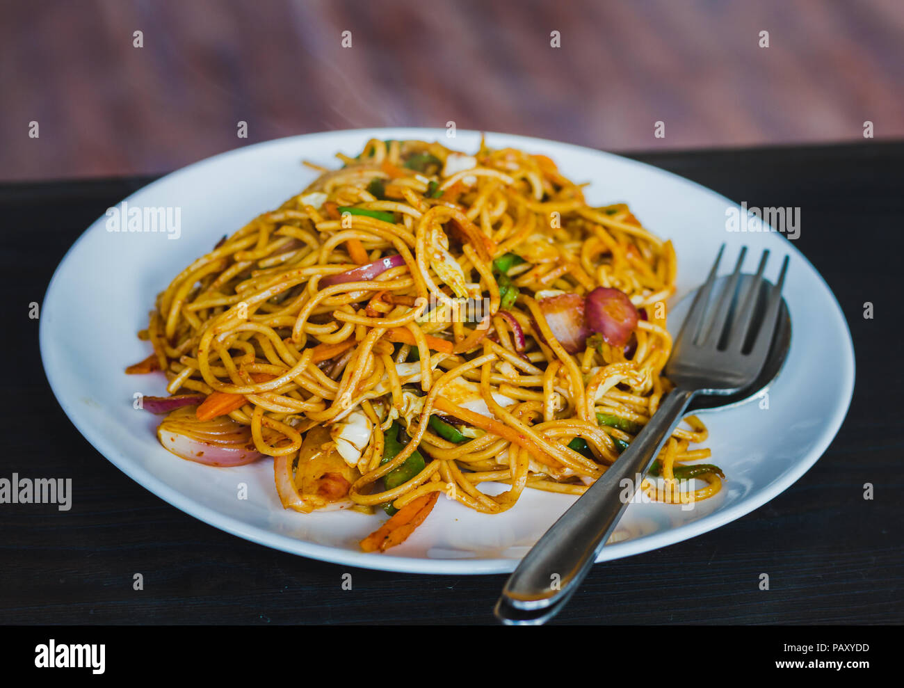 Chinese Noodles, Chowmein on a Plate with Spoon and Fork,Hot and Fresh
