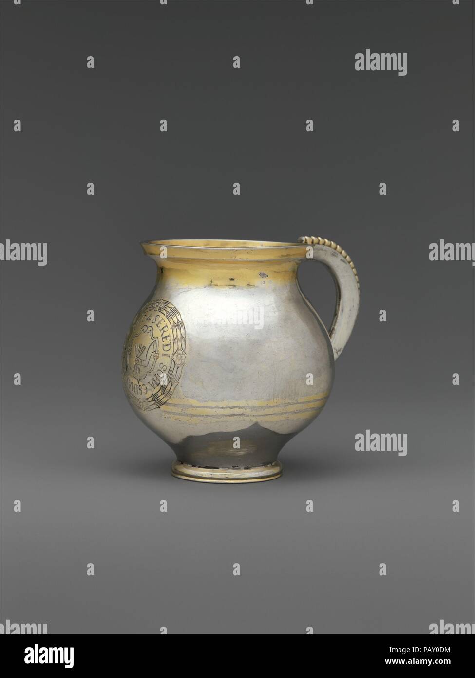 Mug. Culture: Hungarian, Transylvania. Dimensions: Overall: 3 7/8 x 2 15/16 in. (9.8 x 7.4 cm). Date: 1704.  This mug is engraved with the coat of arms of the Serédi family and an inscription that states Sofia Serédi commissioned the piece in 1704. She was married to István Andrássy (1650-1725), a general under Francis II Rákóczi (1676-1735), who fought in an uprising against the Habsburg emperor from 1703 to 1711. Several pieces from the Salgo Collection were once part of the Andrássy treasury.  Literature  <i>European Silver</i>. Sale cat., Sotheby's, Geneva, May 8, 1989, p. 71, no. 205.  Ju Stock Photo