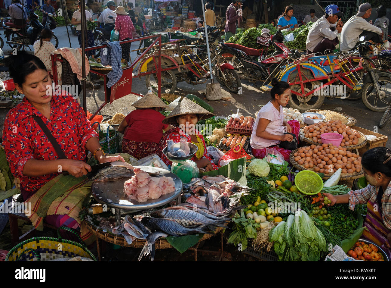 Vegetable sellers in the city centre street market in Mandalay, Myanmar. Stock Photo