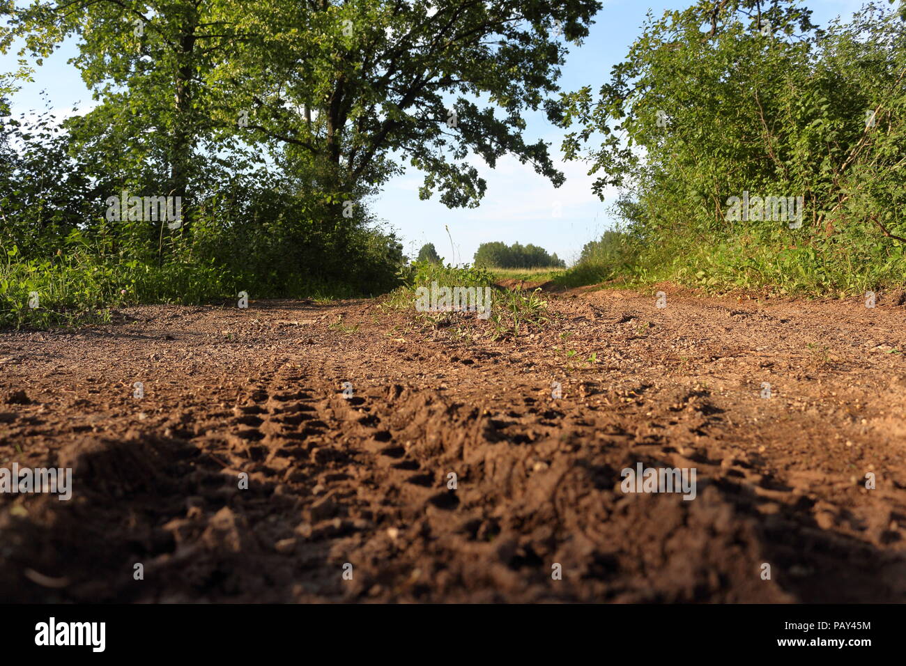 Rough surface of a country road with a tint of red signifying soil rich in iron Stock Photo