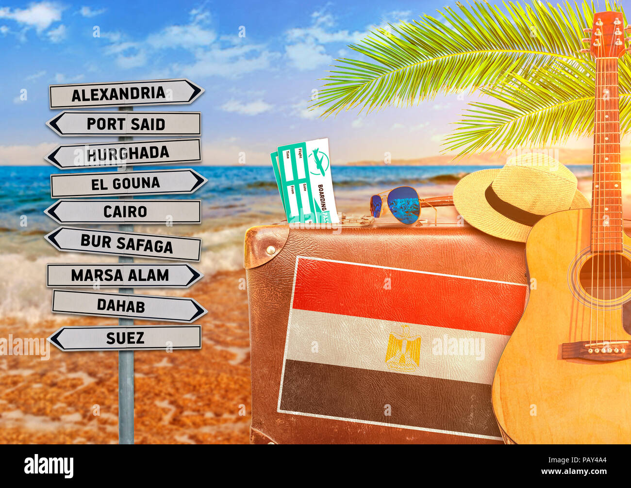 Concept of summer traveling with old suitcase and Egypt town sign Stock