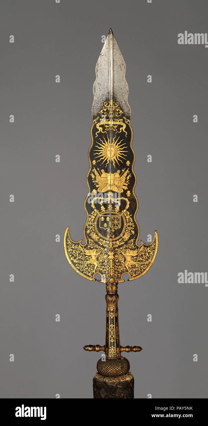 Partisan Carried by the Bodyguard of Louis XIV (1638-1715, reigned from 1643). Culture: French, Paris. Dimensions: L. 94 1/8 in. (239 cm); L. of head 22 9/16 in. (57.3 cm); W. of head 6 1/2 in. (16.5 cm). Sword cutler: Inscription probably refers to Bonaventure Ravoisie (French, Paris, recorded 1678-1709). Date: ca. 1678-1709.  This partisan, along with two like it also in the Metropolitan Museum's collection (acc. nos. 14.25.454, 04.3.64), are thought to have been carried by the Gardes de la Manche (literally, 'guards of the sleeve,' indicating their close proximity to the king), an elite uni Stock Photo