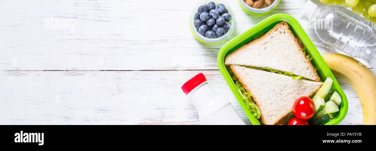 Lunch box with sandwich, vegetables, yogurt, nuts and berries Stock