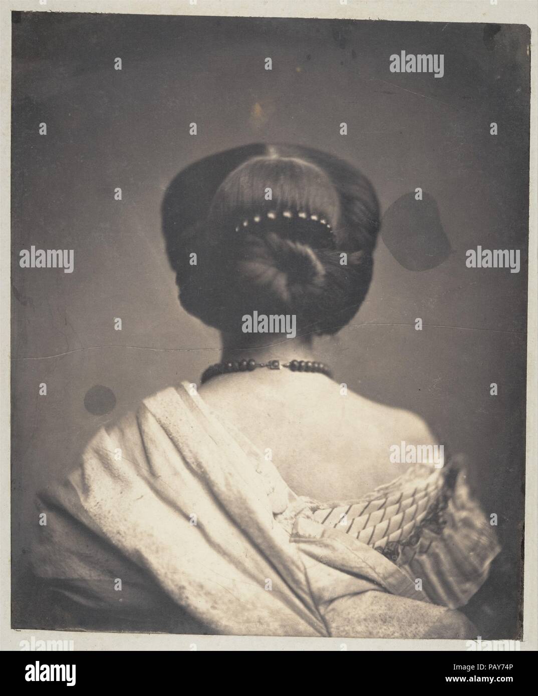 [Woman Seen from the Back]. Artist: Onésipe Aguado de las Marismas (French, Evry 1830-1893 Paris). Dimensions: Image: 30.8 × 25.7 cm (12 1/8 × 10 1/8 in.)  Mount: 39.4 × 31 cm (15 1/2 × 12 3/16 in.). Date: ca. 1862.  A wealthy amateur photographer and a familiar figure at the French imperial court, the viscount Onésipe-Gonsalve Aguado de Las Marismas joined the Société Française de Photographie in 1858. With his better-known brother Olympe, a founding member of the society, Onésipe Aguado was among the early makers of photographic enlargements. The two brothers also collaborated on tableaux vi Stock Photo