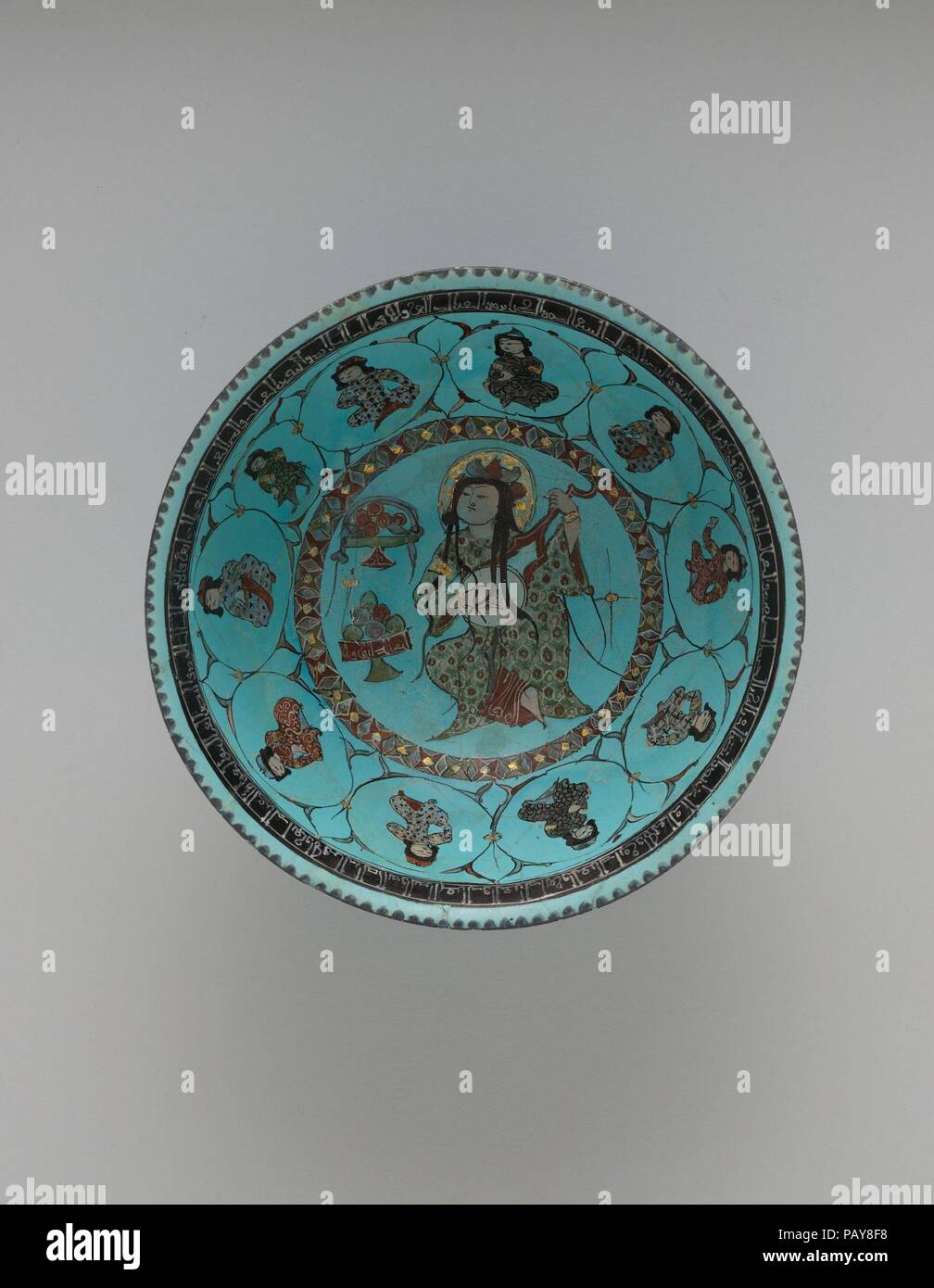 Turquoise Bowl with Lute Player and Audience. Dimensions: H. 3 1/2 in. (8.9 cm)  Diam. 7 3/4 in. (19.7 cm)  Wt. 12.3 oz. (348.7 g). Date: late 12th-early 13th century.  A large assembly with an audience of ten people, or singers, surrounding the 'ud-player is depicted on this turquoise bowl. Bowls of fruit suggest the festive nature of the event. Museum: Metropolitan Museum of Art, New York, USA. Stock Photo