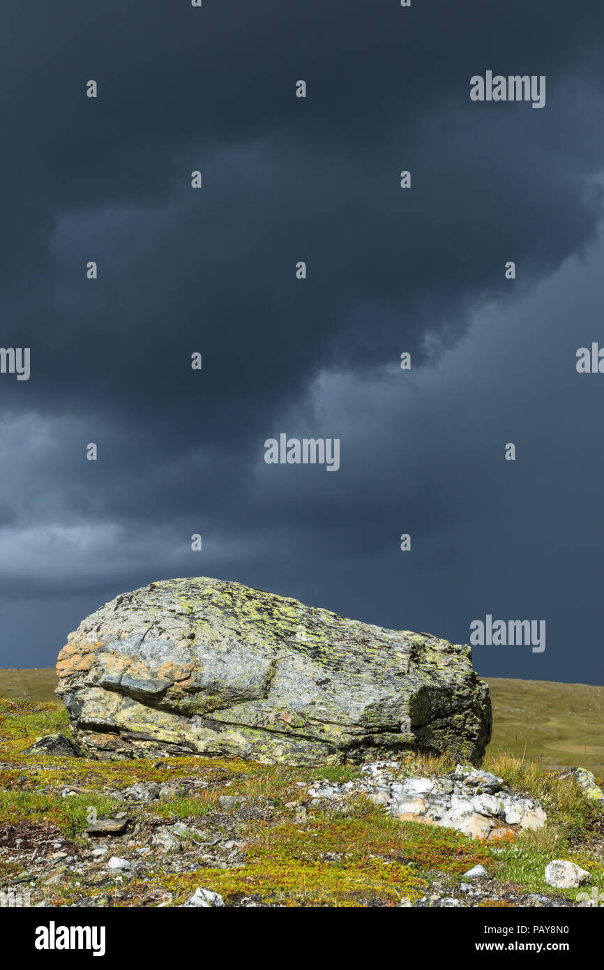 Rocks with dark thunderstorm clouds in the sky Stock Photo