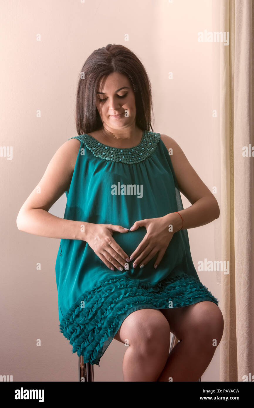A young pregnant woman is expecting the birth of her first child Stock Photo