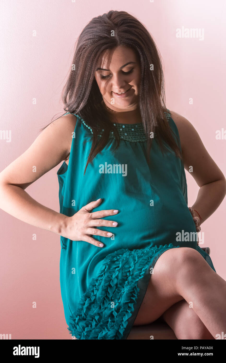 A young pregnant woman enjoys maternity Stock Photo