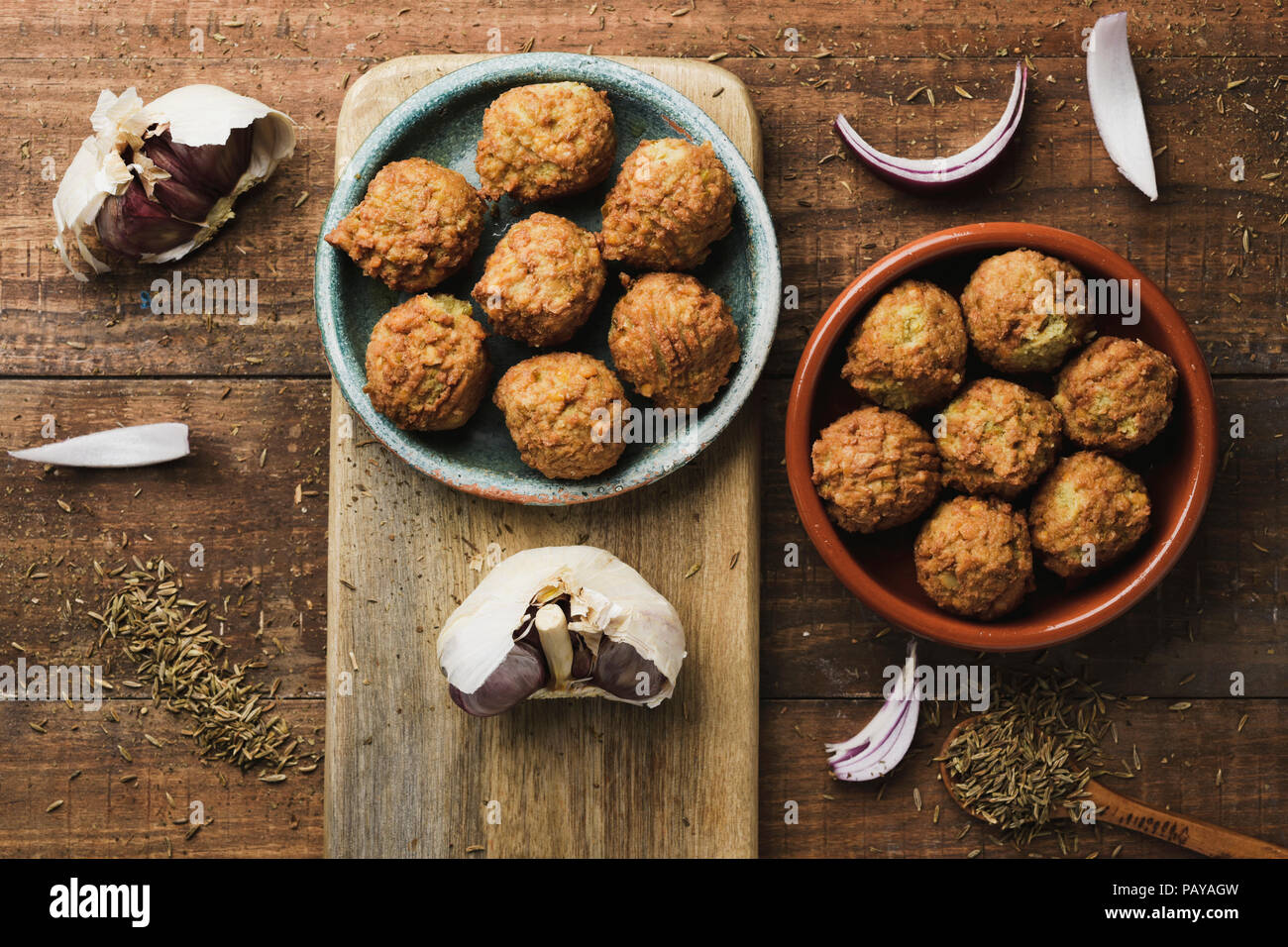 high angle view of some falafel served in two different earthenware plates placed on a rustic wooden table Stock Photo