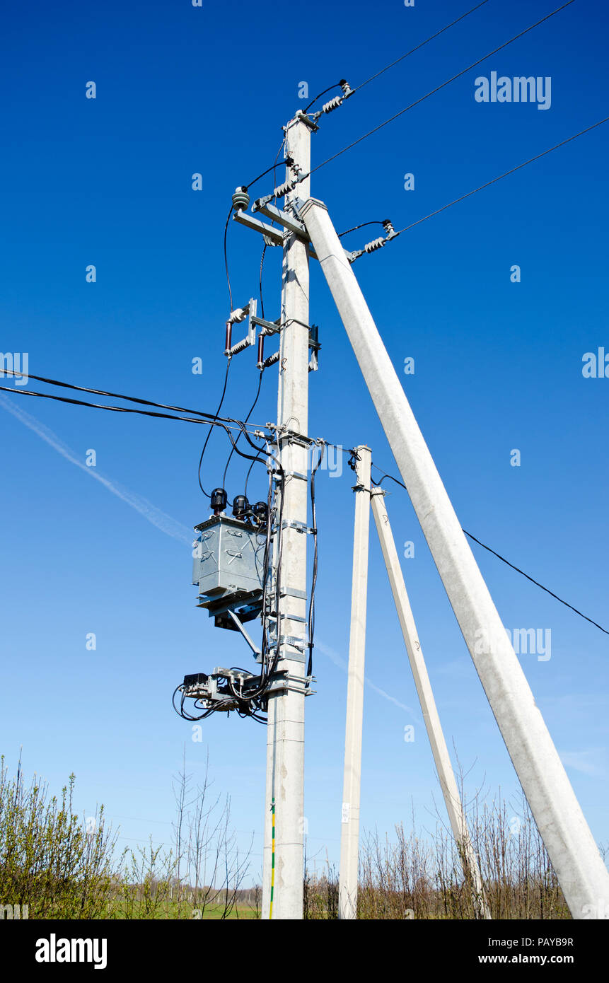 Two electricity pole on farm field in summer Stock Photo - Alamy