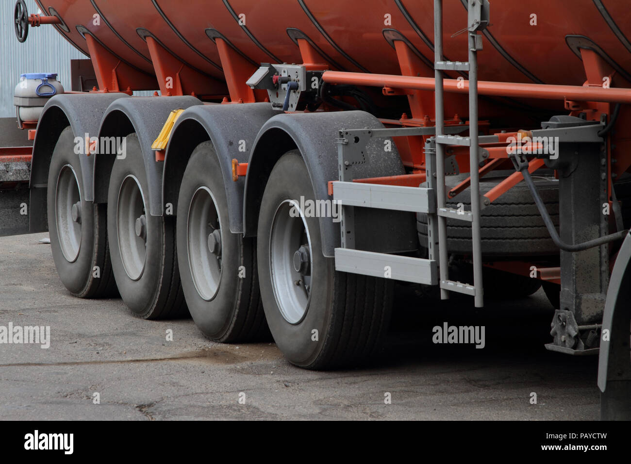 Wheels of multi-axle semi-trailer for transportation of fuel. Stock Photo