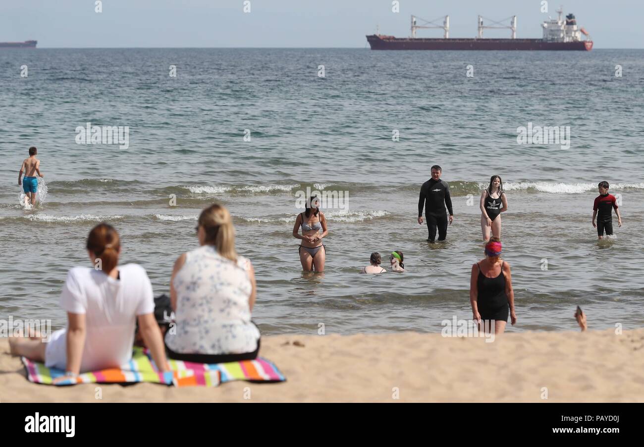 People enjoying the heatwave today on Tynemouth beach on North Tyneside as the hot weather continues across the UK, marking the driest start to a summer since modern records began in 1961. Stock Photo