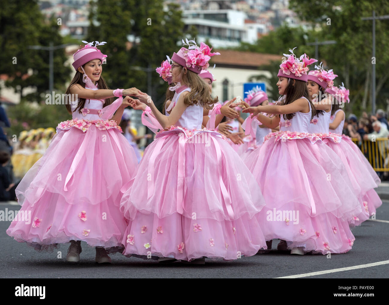 Funchal; Madeira; Portugal - April 22; 2018: A group of girls in pink costumes are dancing at Madeira Flower Festival Parade in Funchal on the Island  Stock Photo