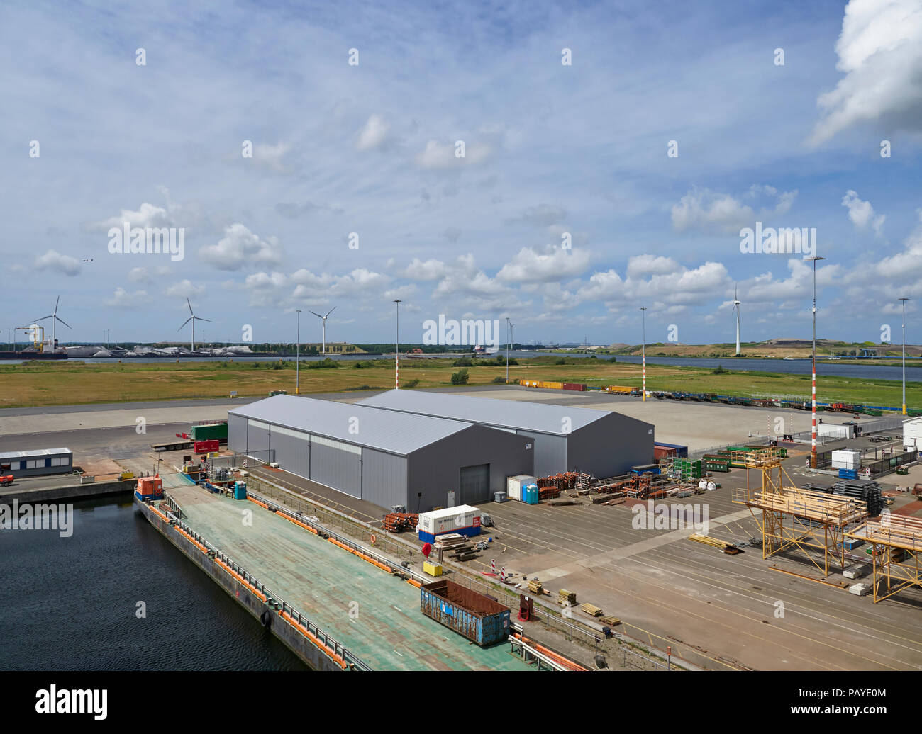 Another View across the Container Port in Den Haag in Amsterdam with Warehouses and Equipment lying on the Large Quay, Den Haag, Holland. Stock Photo