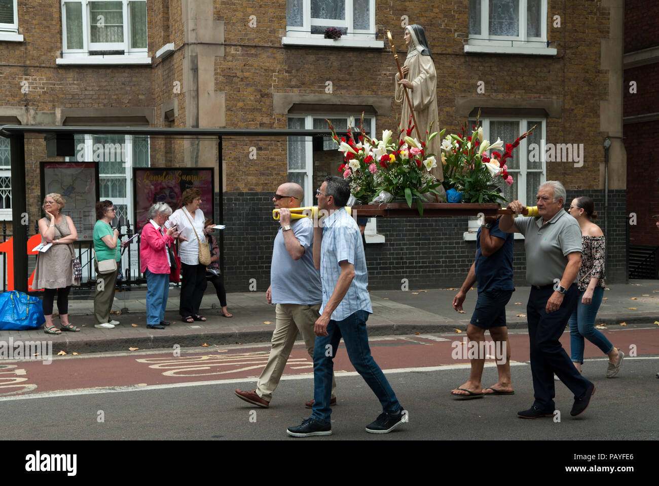 Roman Catholic procession Christianity UK. Italian community annual procession in Honour of Our Lady of Mount Carmel. St Peters Italian Church, Clerkenwell, London people watching religious statue pass by. 2018 2010s HOMER SYKES Stock Photo