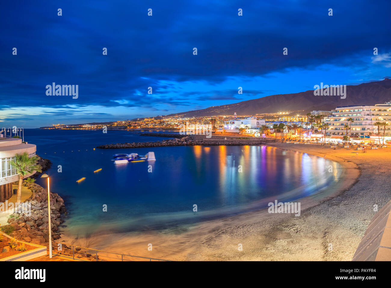 Beautiful night scene over Pinta beach with colorful lights reflected in the sea in Tenerife, Canary island, Spain Stock Photo