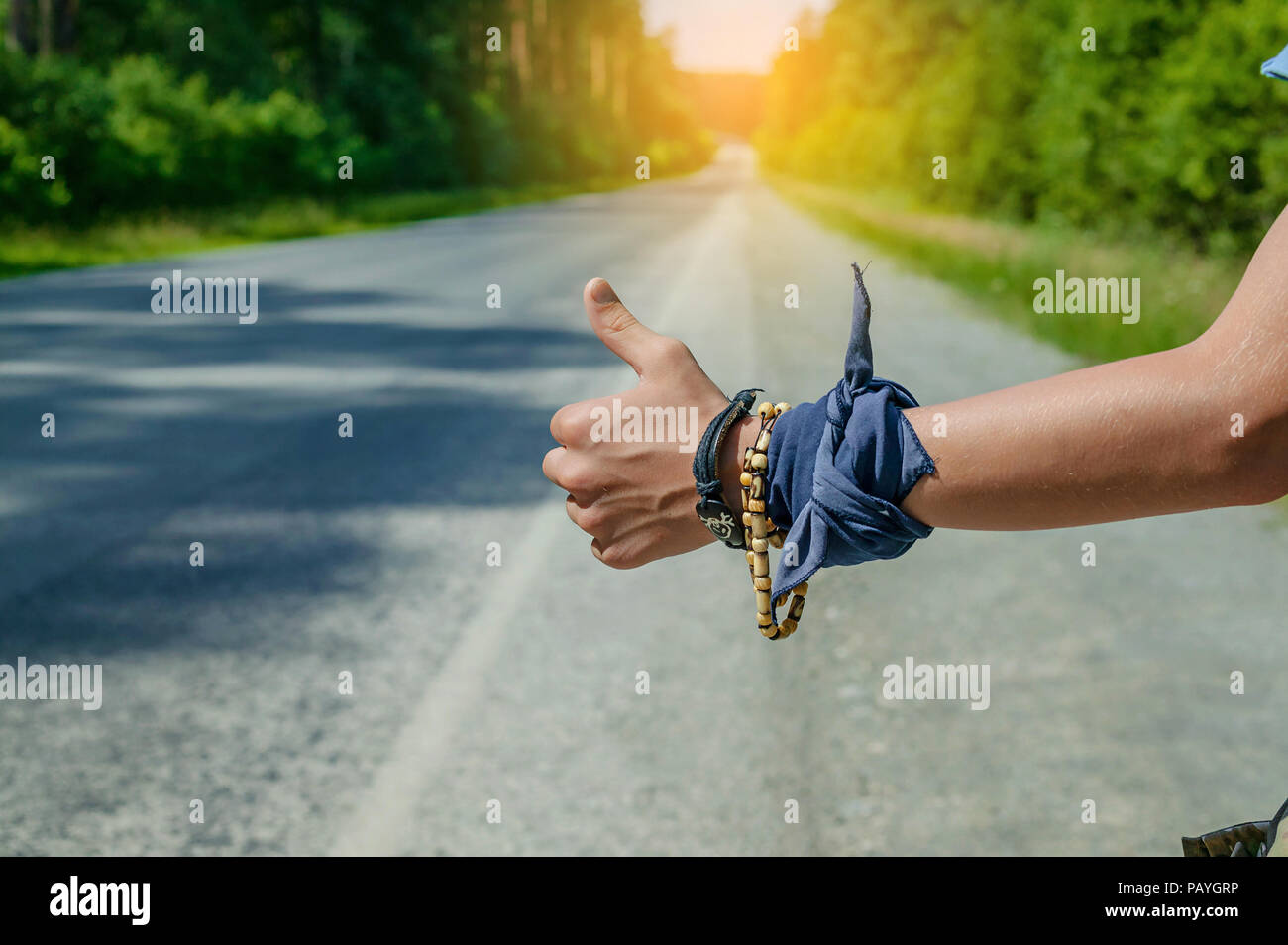 Teenager hitchhiker holding hand gesture to stop a car. Closeup Stock Photo Alamy