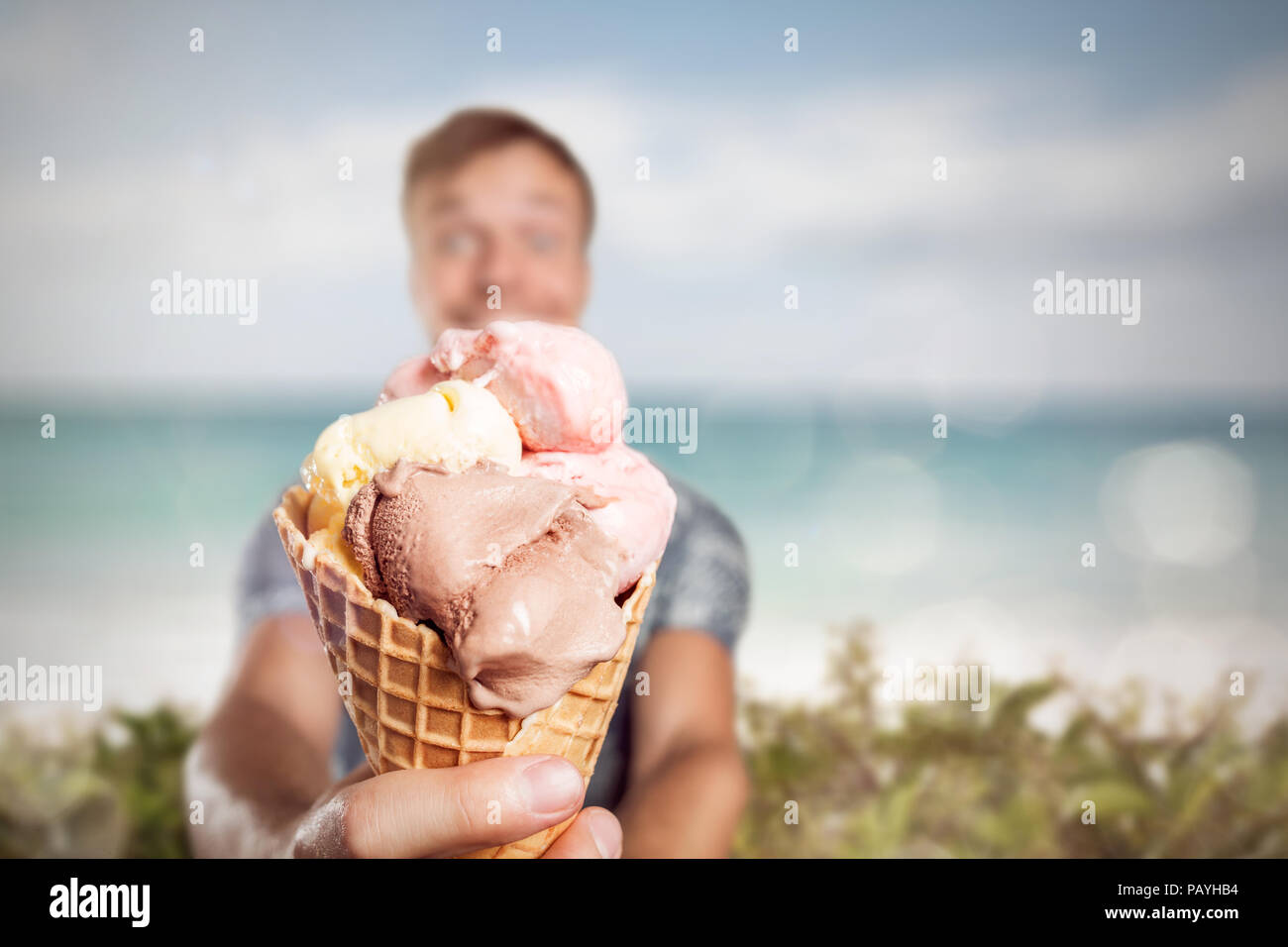 Man holding a large ice cream cone Stock Photo