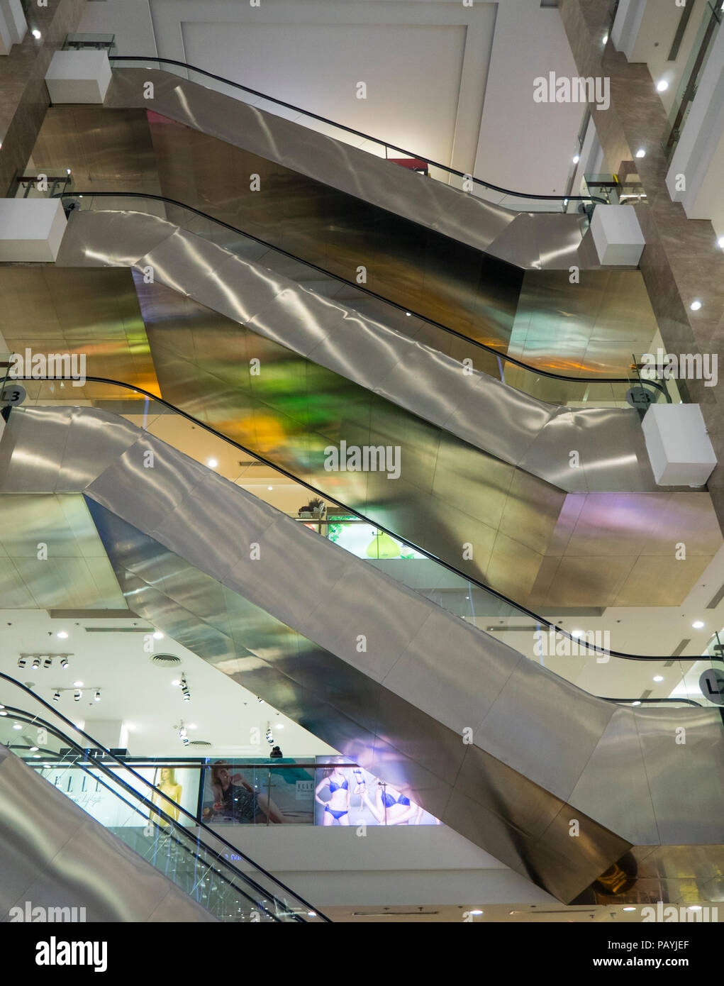 Stainless steel escalators  in a shopping centre in Ho Chi Minh City, Vietnam. Stock Photo