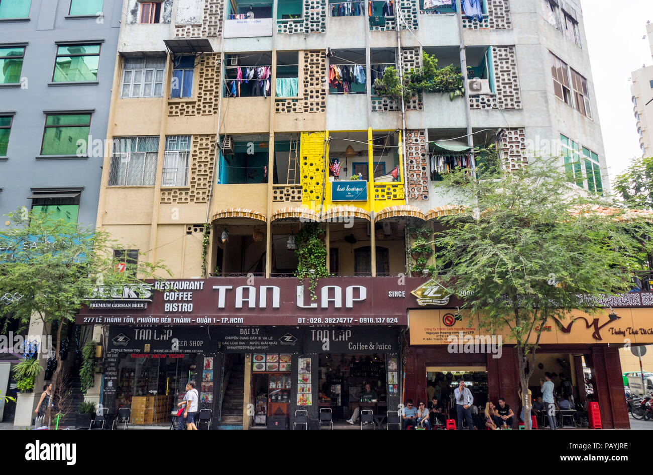 Block of apartments above coffee shops and restaurants in Ho Chi Minh City, Vietnam. Stock Photo