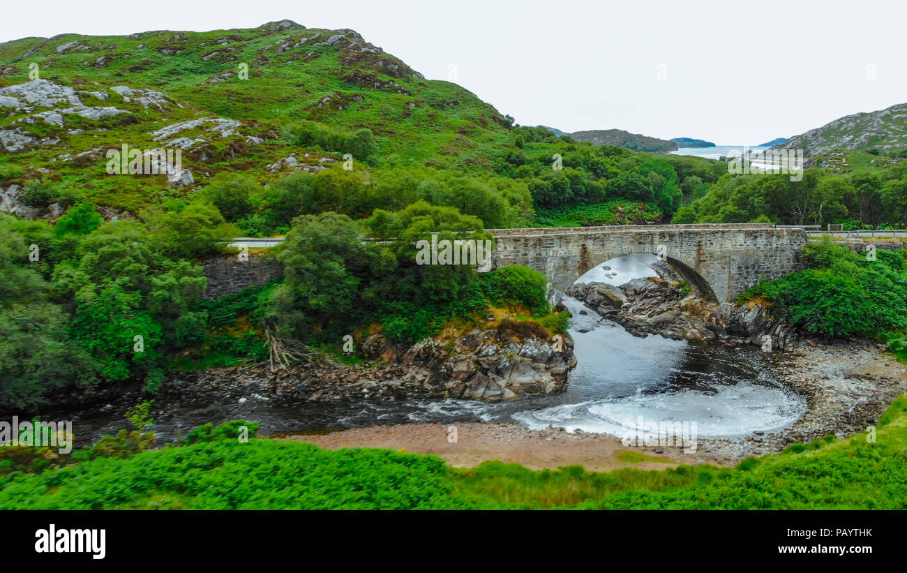 Ancient stone bridge in the Highlands of Scotland - typical scenery Stock Photo