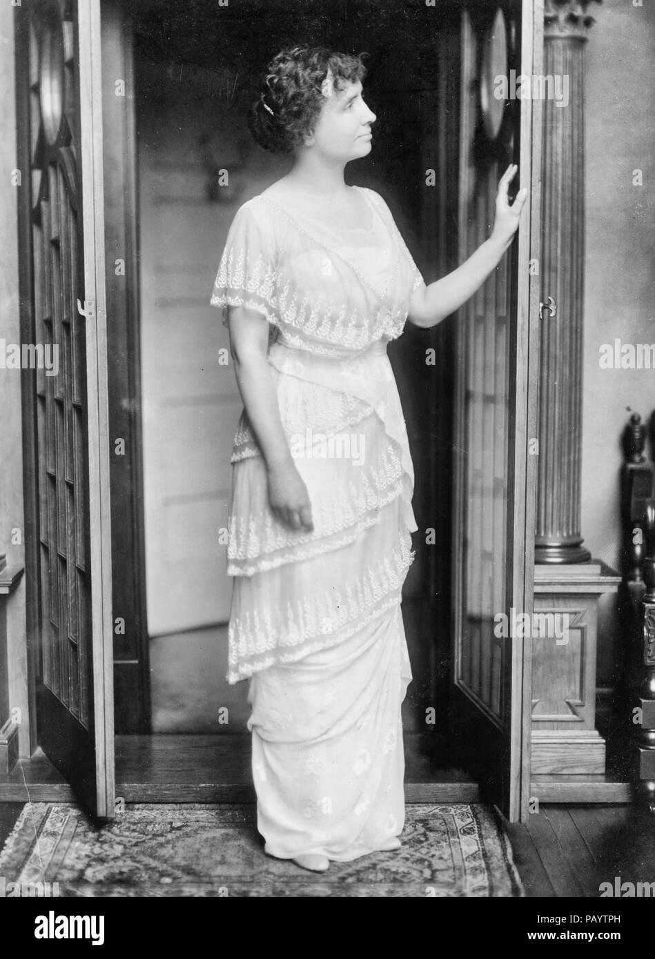 Helen Keller, full-length portrait, standing at door in room, facing right, circa 1914 Stock Photo