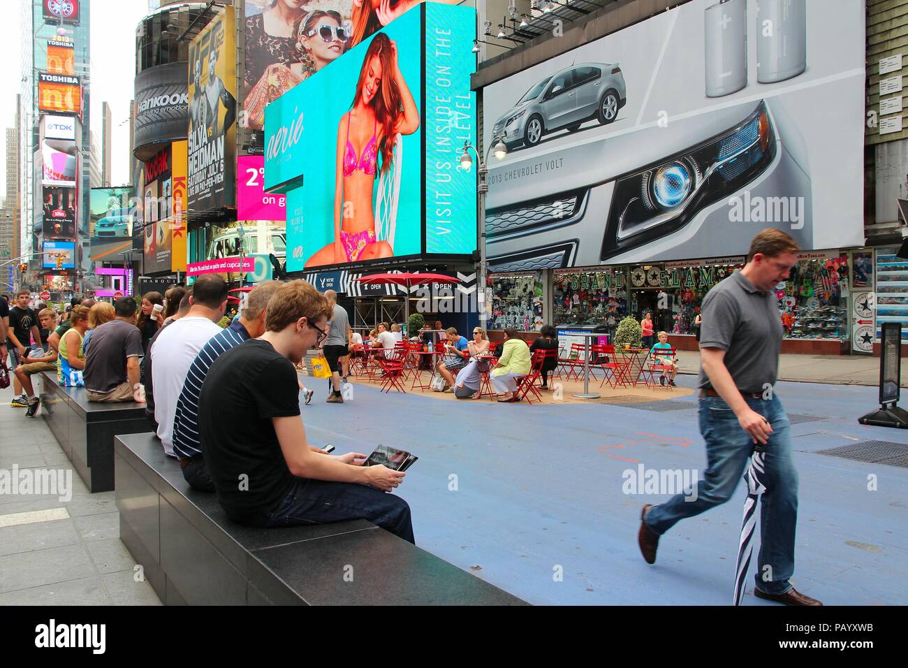 NEW YORK - JULY 3: People visit Times Square on July 3, 2013 in New York. Times Square is one of most recognized landmarks in the world. More than 300 Stock Photo