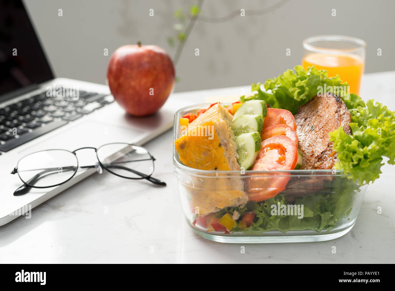 homemade lunch box at modern stylish work place, view from above Stock Photo