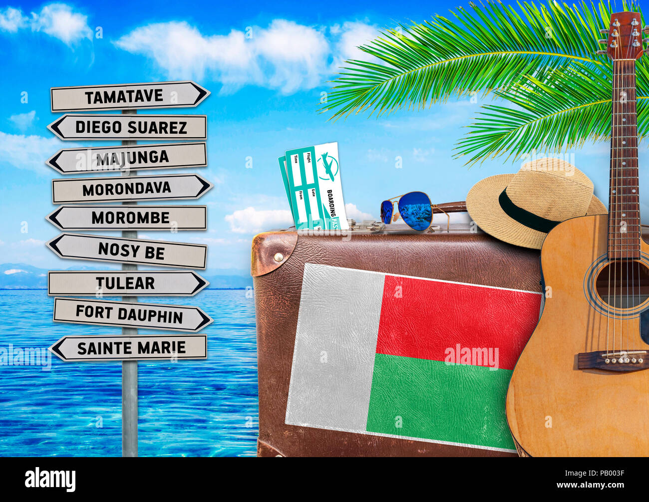 Concept of summer traveling with old suitcase and Madagascar town sign Stock Photo