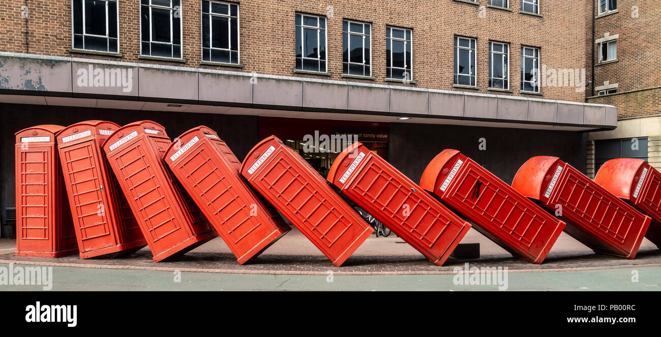 Part of David Mach's art installation 'Out of Order' (1989) featuring  falling over traditional red telephone boxes, in Kingston Upon Thames,  England Stock Photo - Alamy