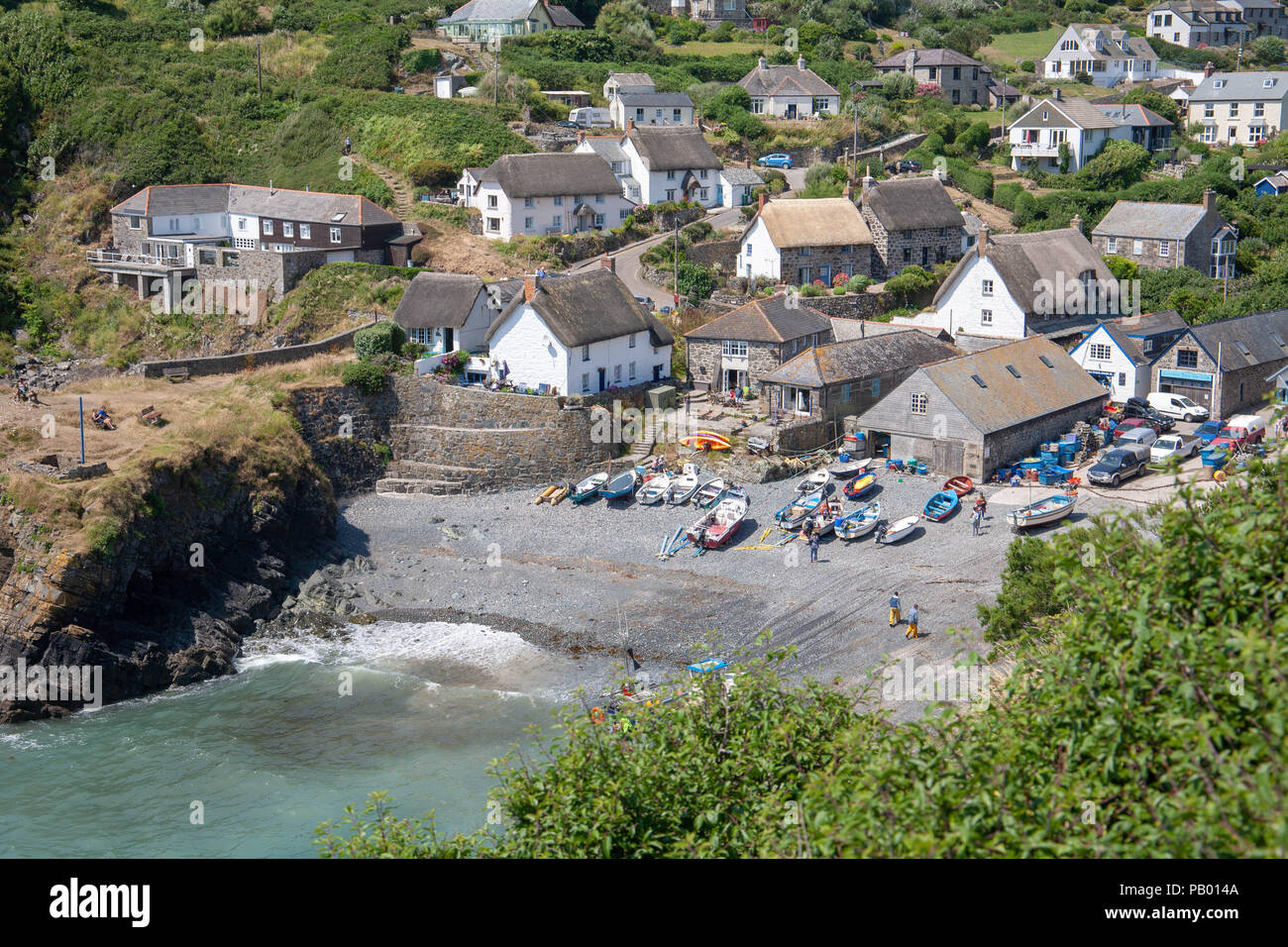 Cadgwith Cove, Cornwall with boats tied up on the beech Stock Photo