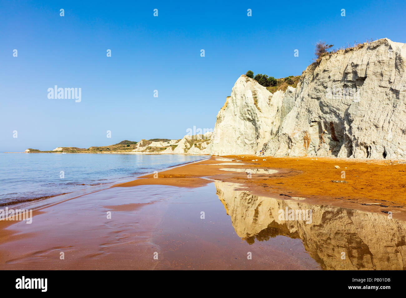 Orange sands beach with high white rocks Stock Photo - Alamy