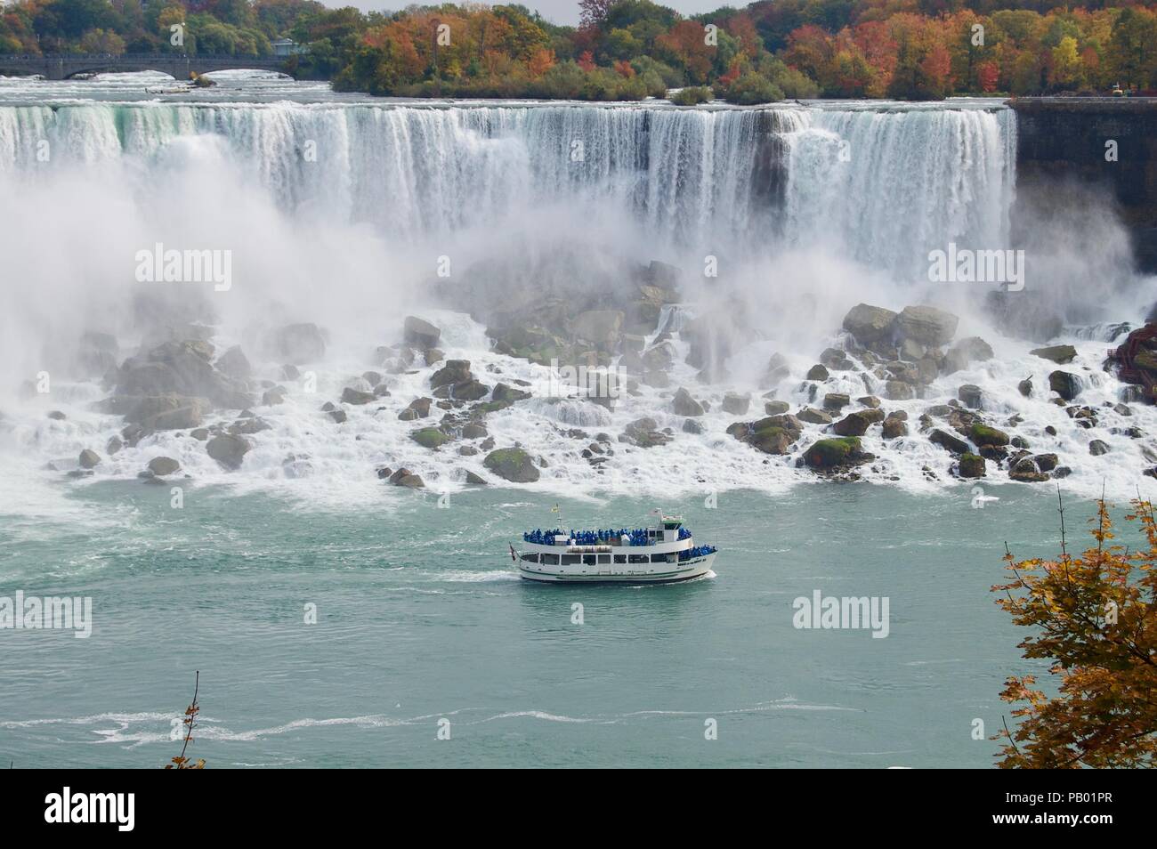 Beautiful and impressive panorama of the Niagara Falls in Ontario (Canada) on a bright colorful autumn day with water crashing down the falls Stock Photo