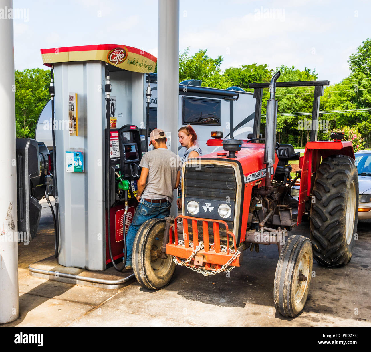 CLARKSVILLE, TN,  USA-29 MAY 18: A young rural couple buy diesel fuel  for their 231 Massey-Ferguson tractor at a credit card pump. Stock Photo