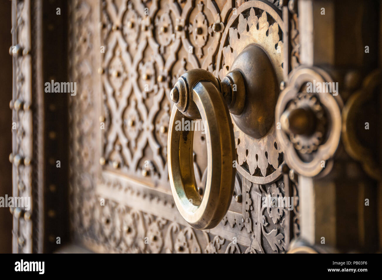 Indian ornate brass door with round handle Stock Photo