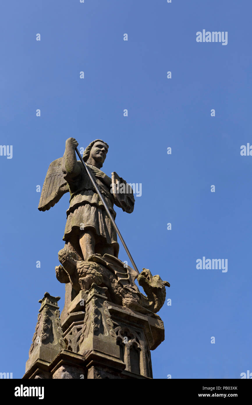 Figure depicting St George on Alnwick Castle in Northumberland, England. The saint is shown slaying a dragon. Stock Photo