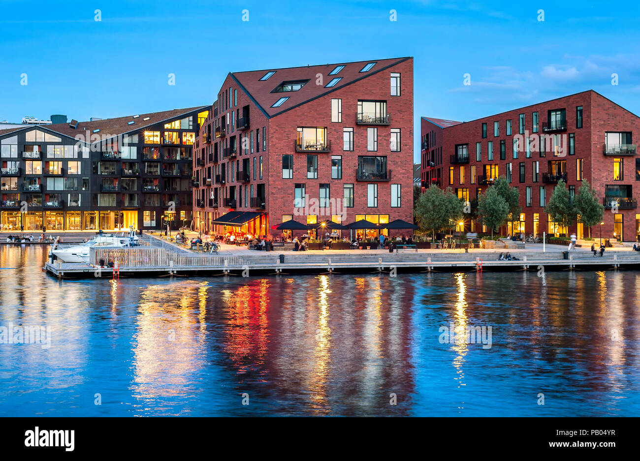 Kroyers Plads buildings of modern architecture design by embankment illuminated at night, Copenhagen, Denmark Stock Photo