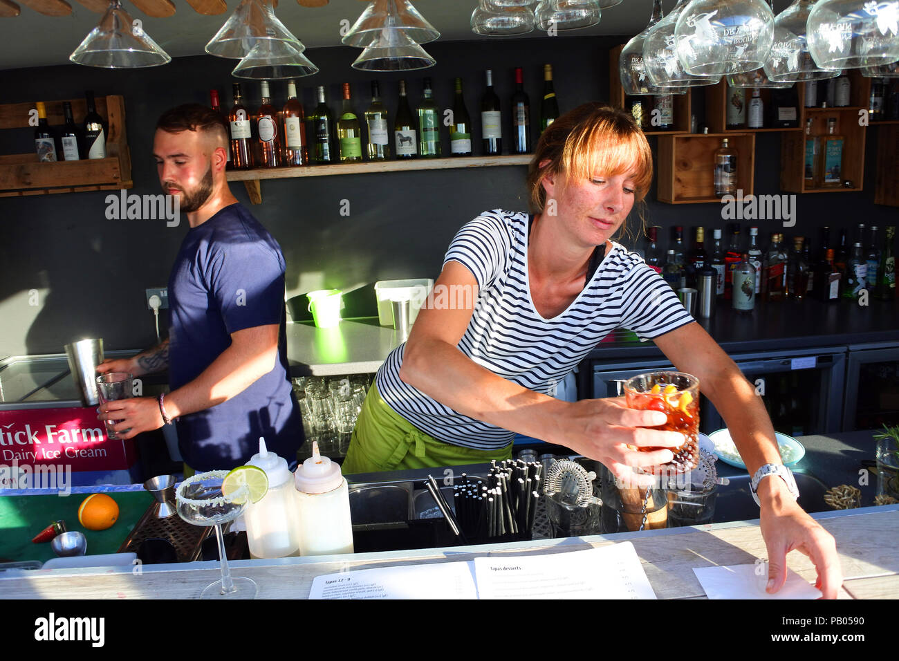 Bartender serving a cocktail - John Gollop Stock Photo