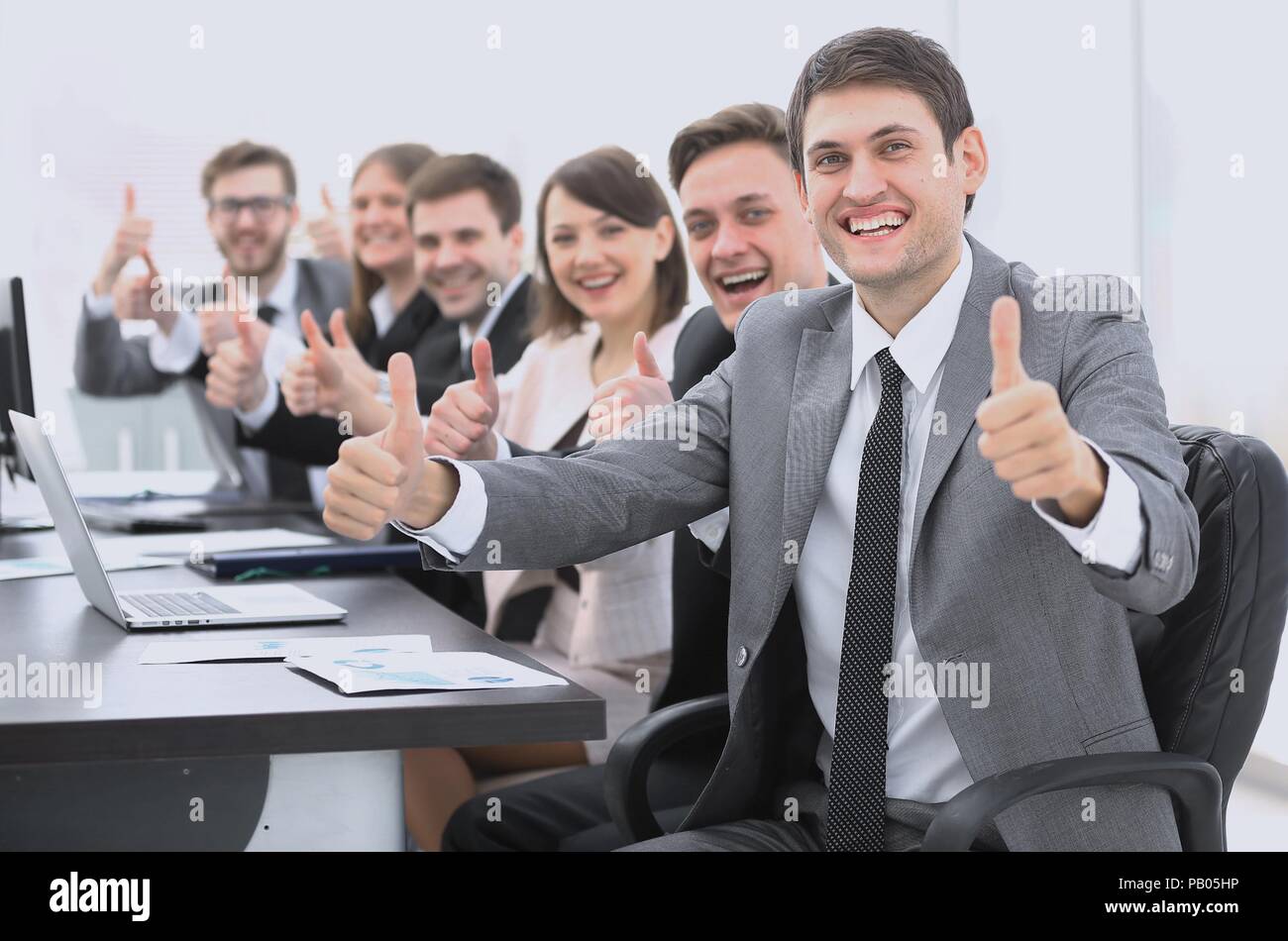 successful business team showing thumbs up Stock Photo - Alamy