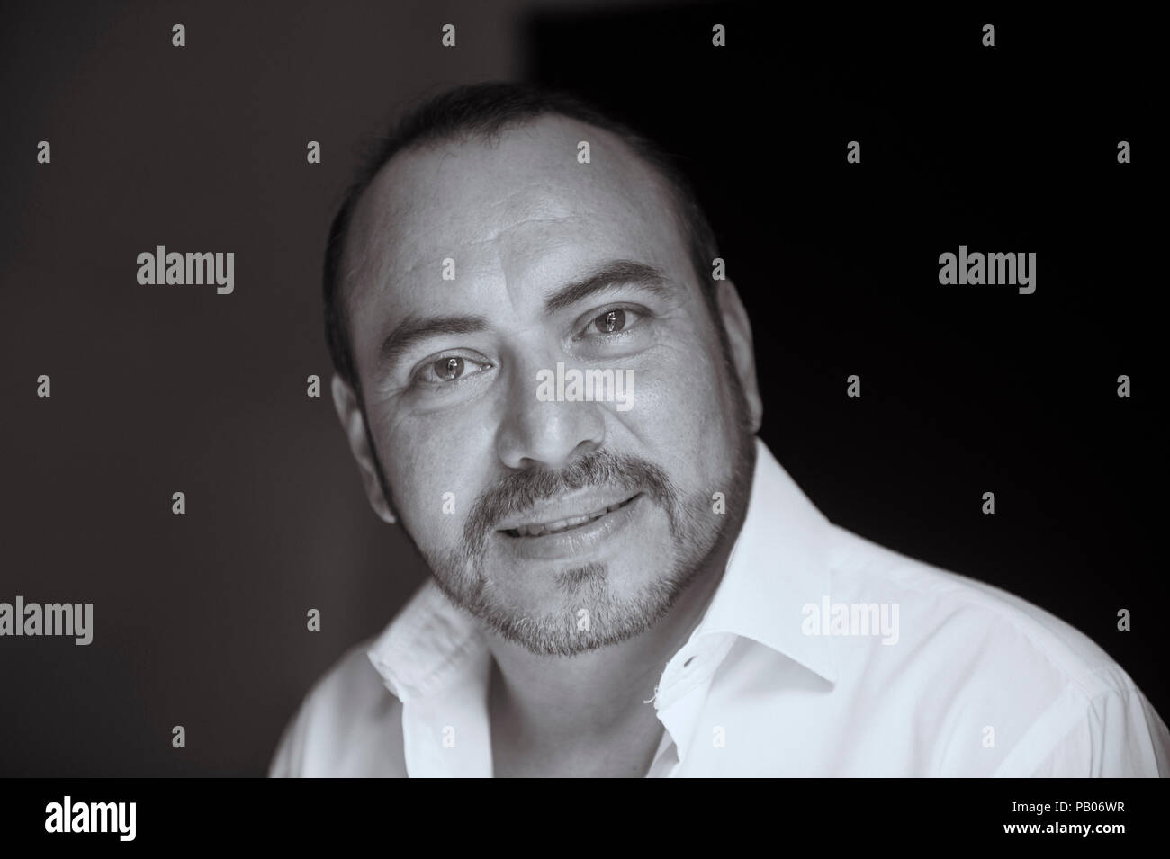 Black and White studio portrait of a man in white shirt Stock Photo
