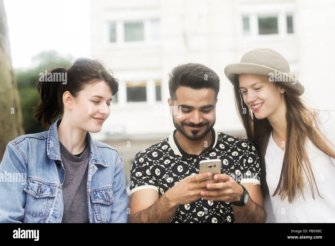 Group men looking at phone laughing hi-res stock photography and images ...