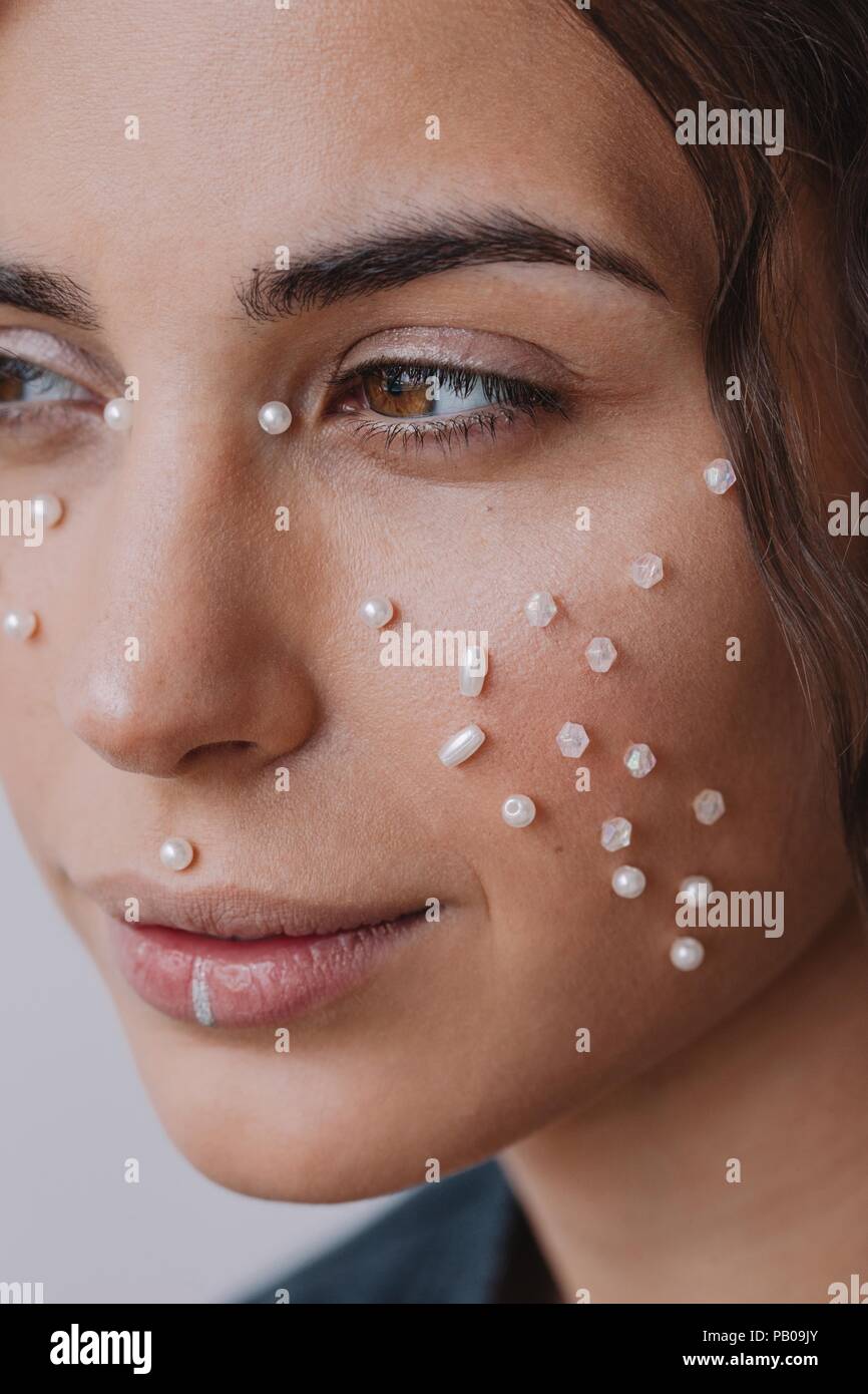 Close-up of a woman with pearls on her face Stock Photo