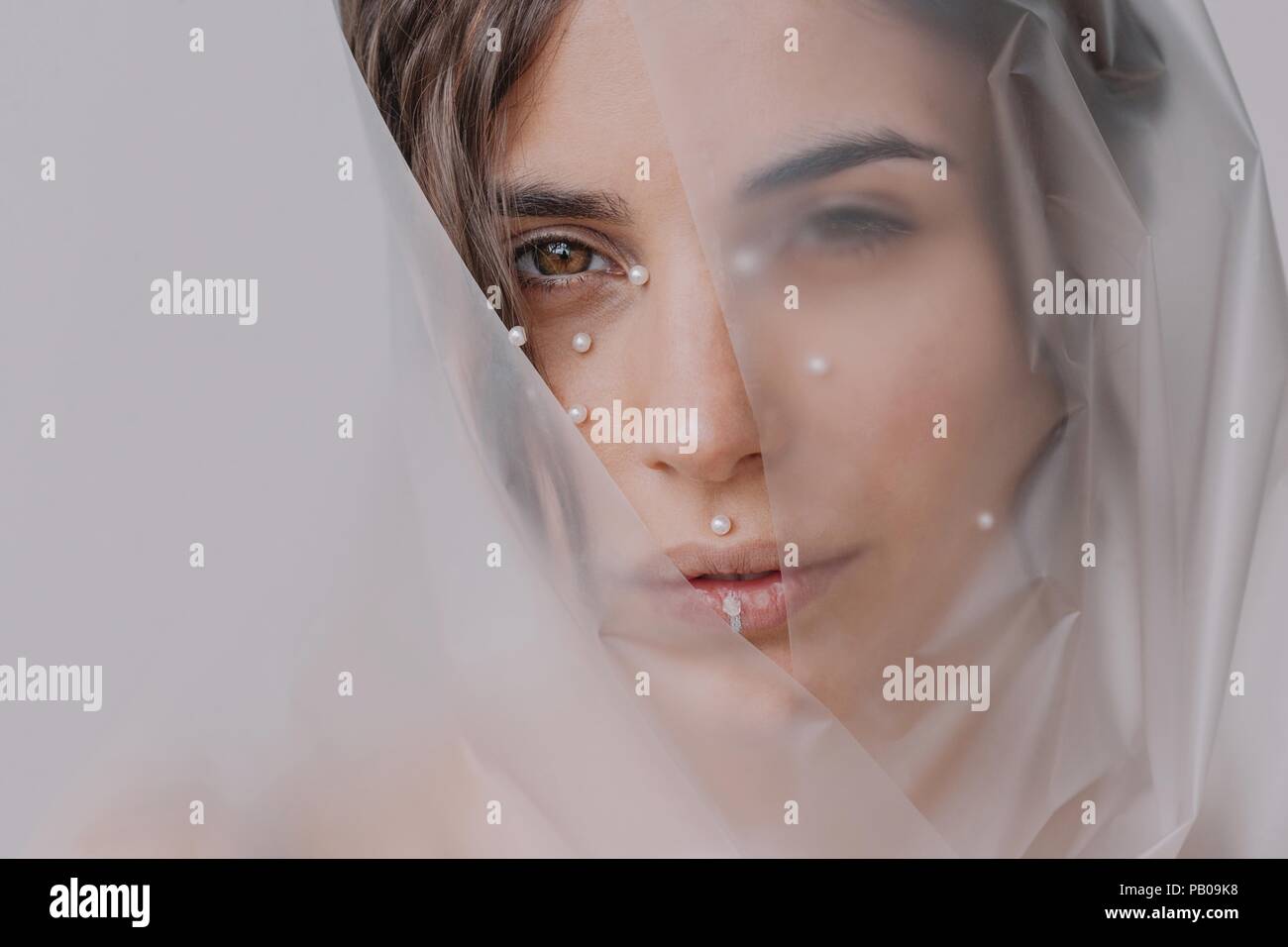 Portrait of a woman with pearls on her face Stock Photo